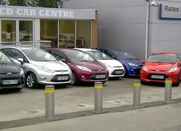 Rising bollards protecting cars at Ford dealership