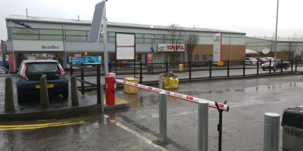bollards integrated with fixed install barrier at commercial premise car park