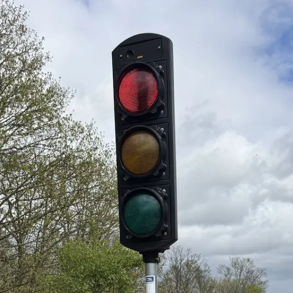 Traffic signal head showing red on road networks.