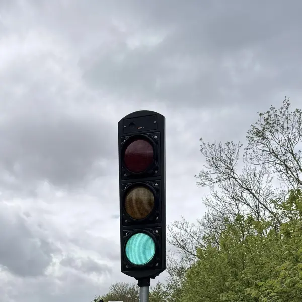 Traffic signal head showing green on road networks.