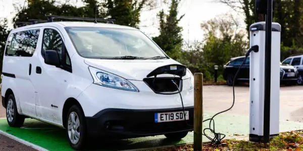 Van plugged into EV charging station