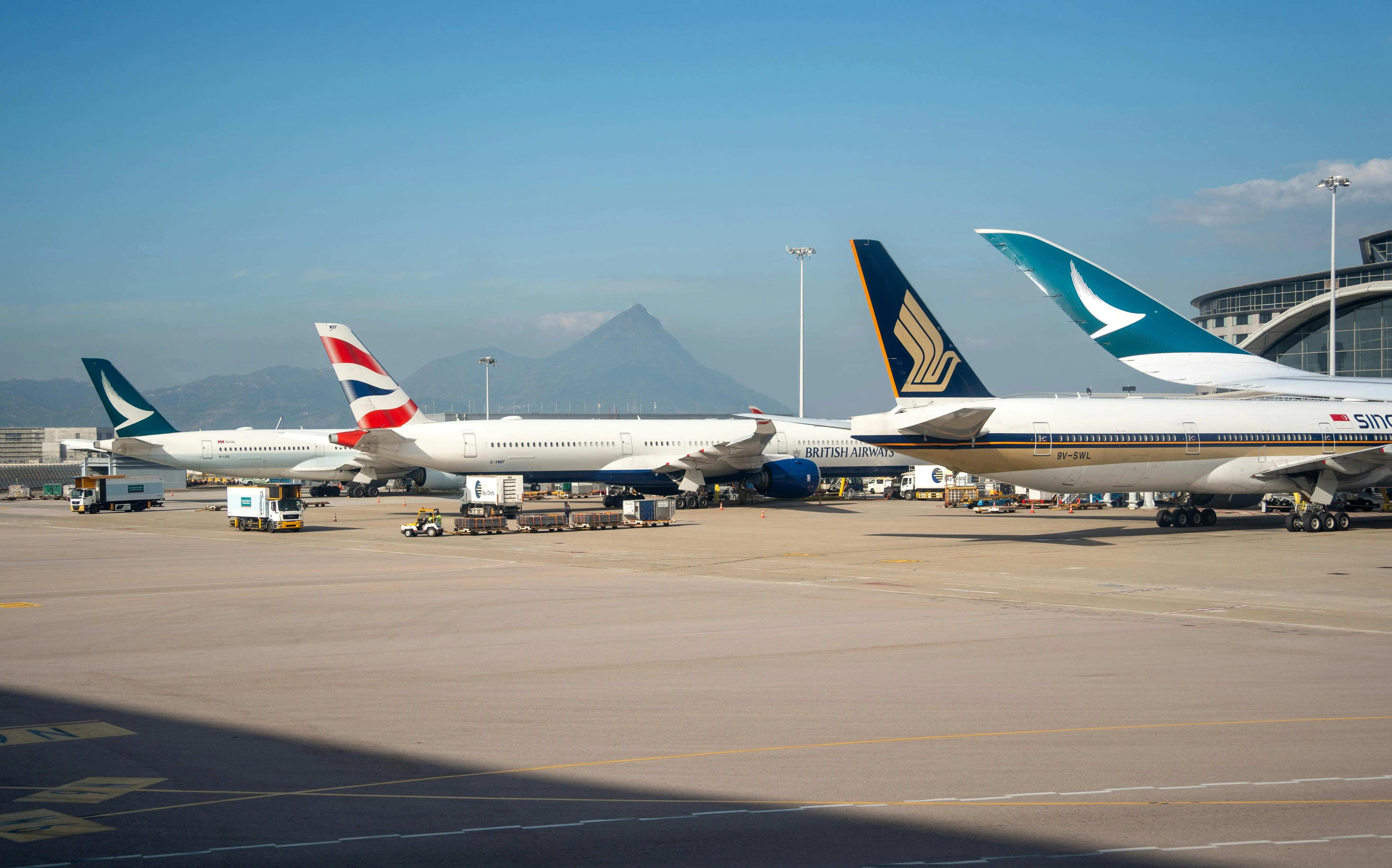airplanes lined up at airport terminals