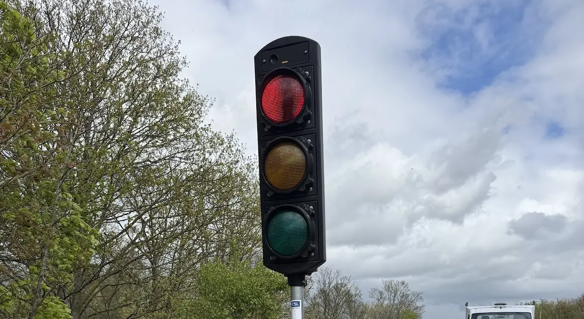Traffic signal head showing red light.